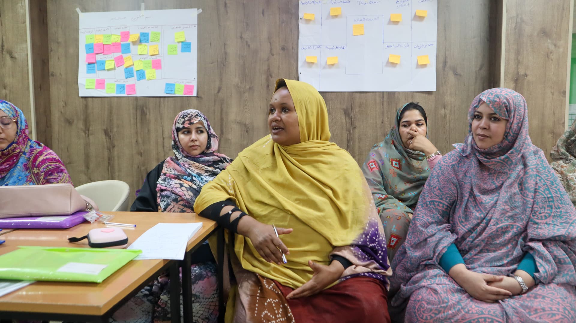 Participants seated around a table during a classroom training session