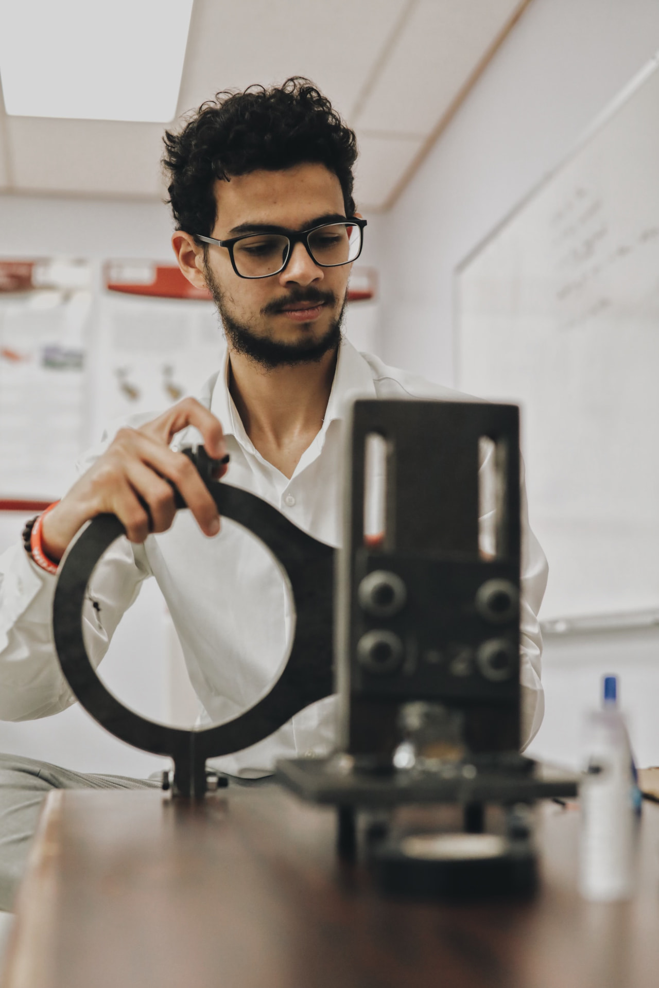 A student in safety glasses working with laboratory research equipment